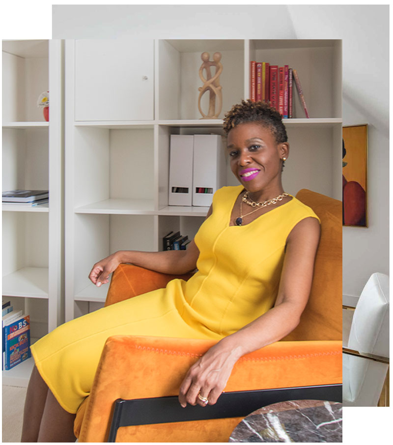 in-page-img-conceirge-pg Dr Darby sitting in an orange chair in a yellow dress