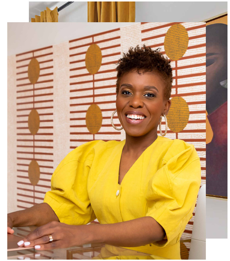 Dr Darby sitting at a desk wearing a yellow dress